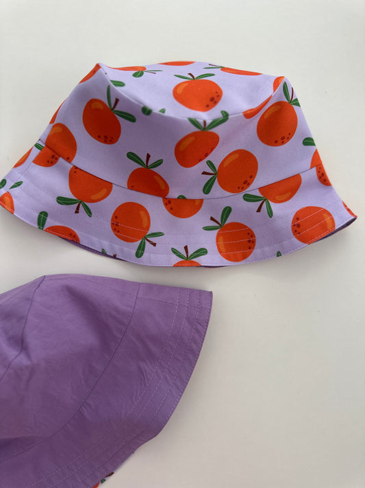 Reversible children's bucket hat with UV protection - oranges