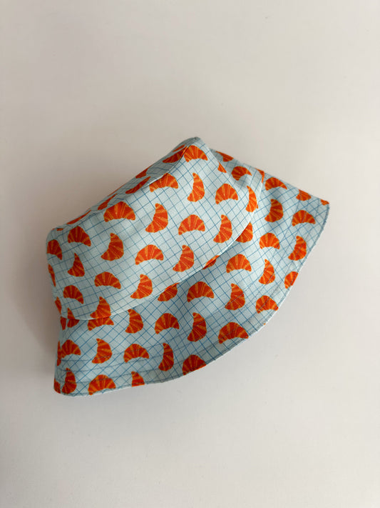 *PRE-ORDER* Двулицева детска шапка Bucket hat с естествена UV бариера - кроасани светло сини SS26